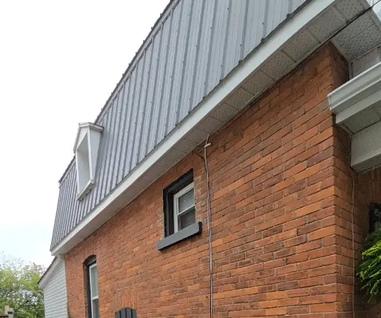 Red brick side wall of a house before painting