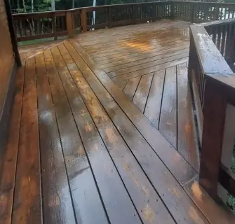 Freshly stained deck boards and railing, still glossy