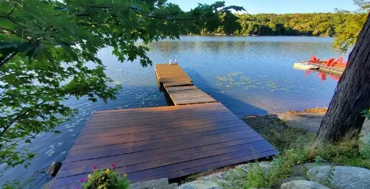 Stained wooden dock on a calm lake