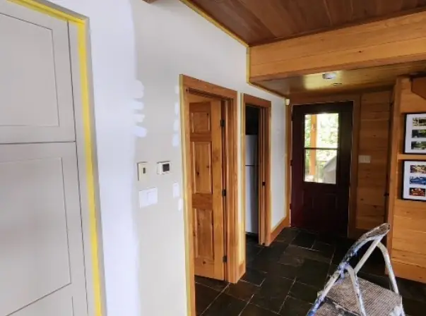 Door trim masked with tape before painting