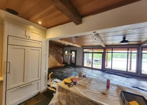 Kitchen island wrapped in plastic during painting
